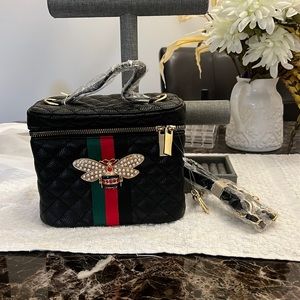 Small black new quilted material handbag with zipper.
